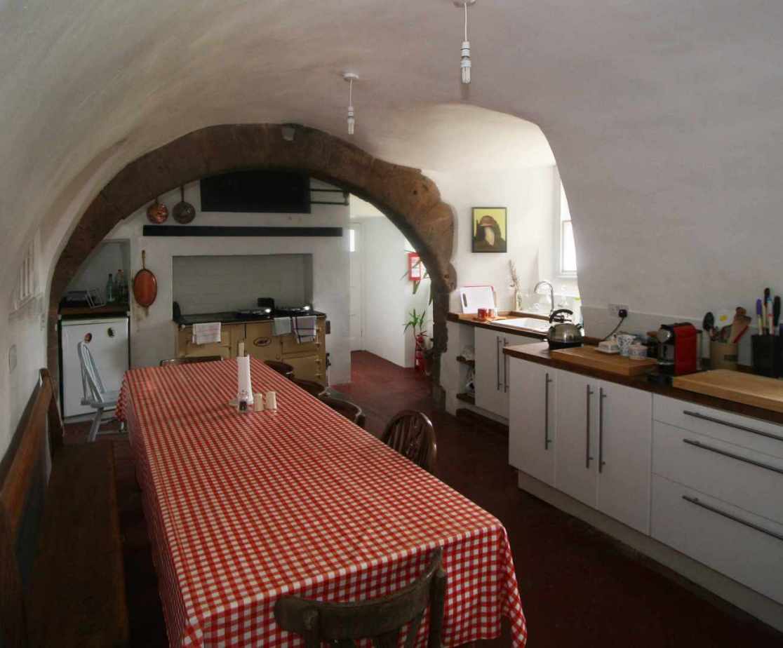 The vaulted kitchen is located at ground level