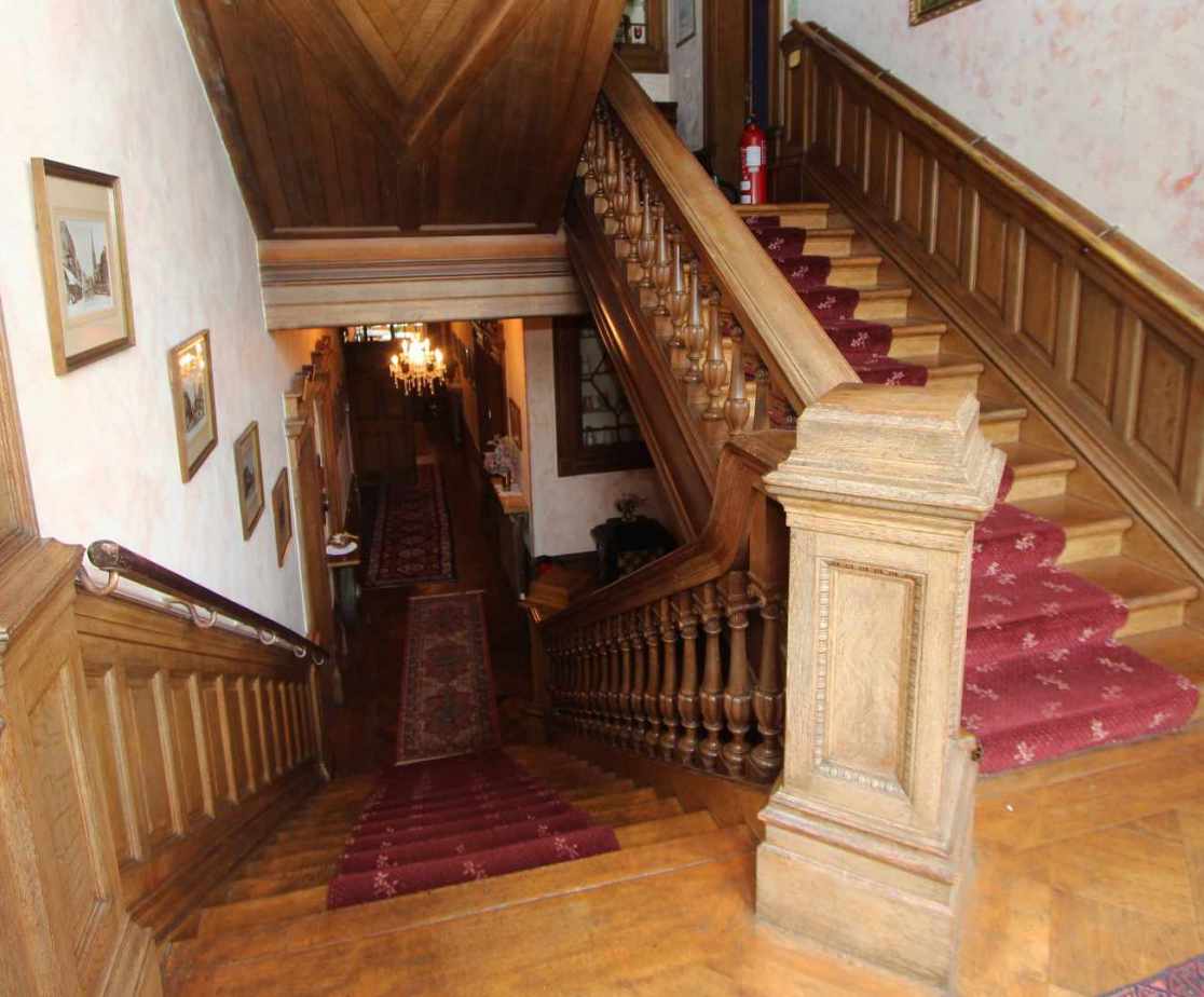 The fine wooden staircase leads you to the accommodation above