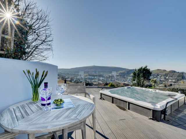 The decked terrace area with hot tub and magnificent views