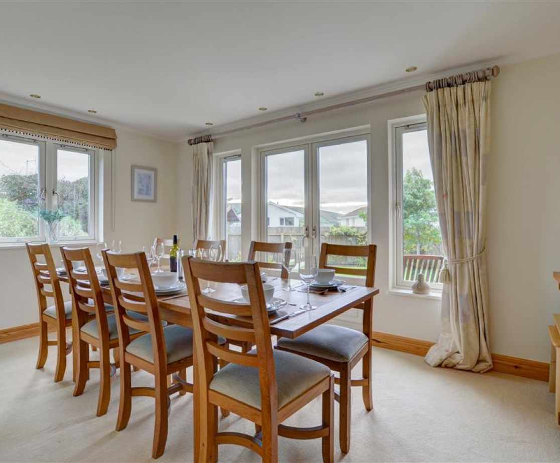 A large separate dining room with French doors also opening to the garden offers a more elegant option for dining