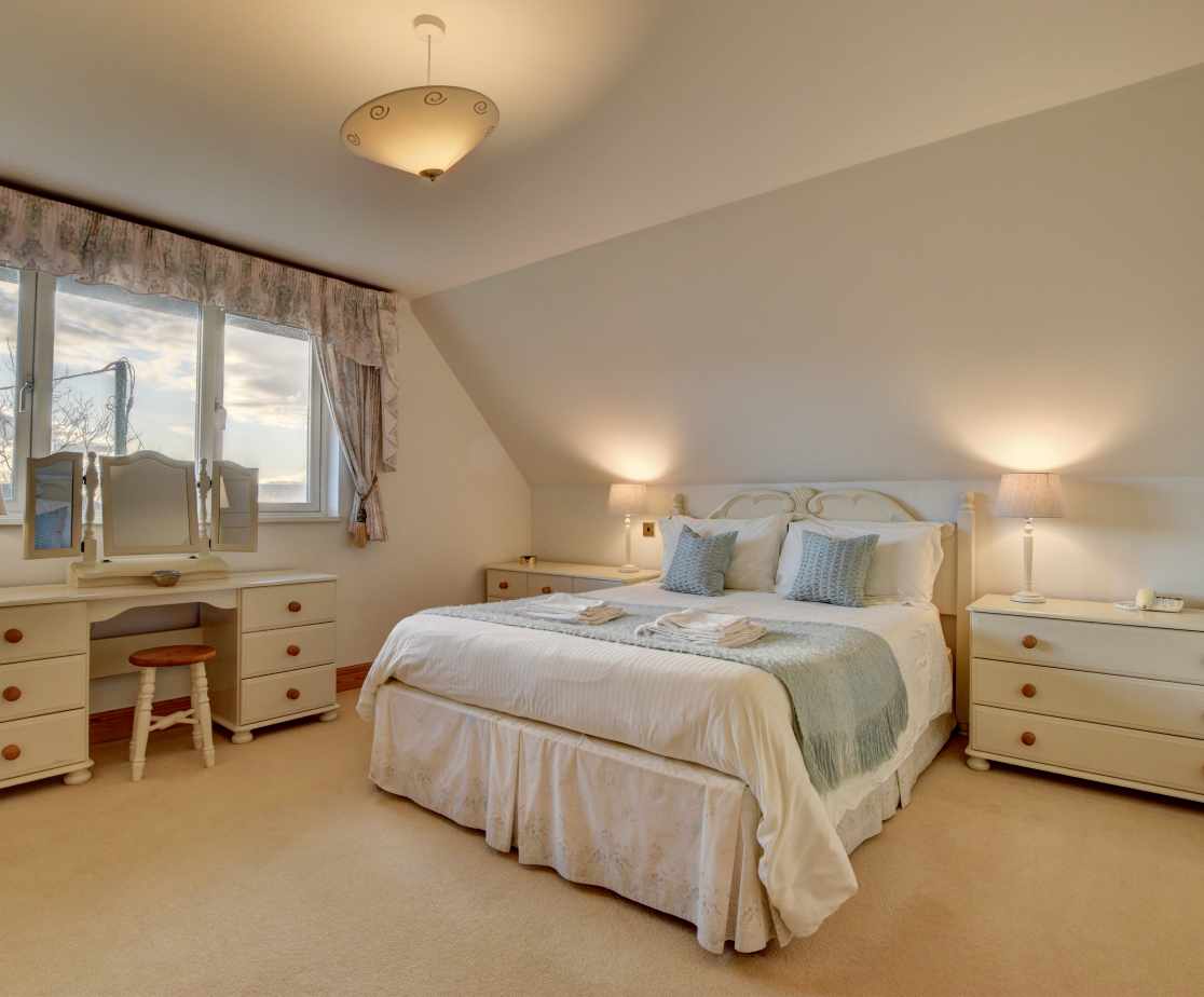 The beautiful master bedroom has views over Croyde, sand dunes and the sea