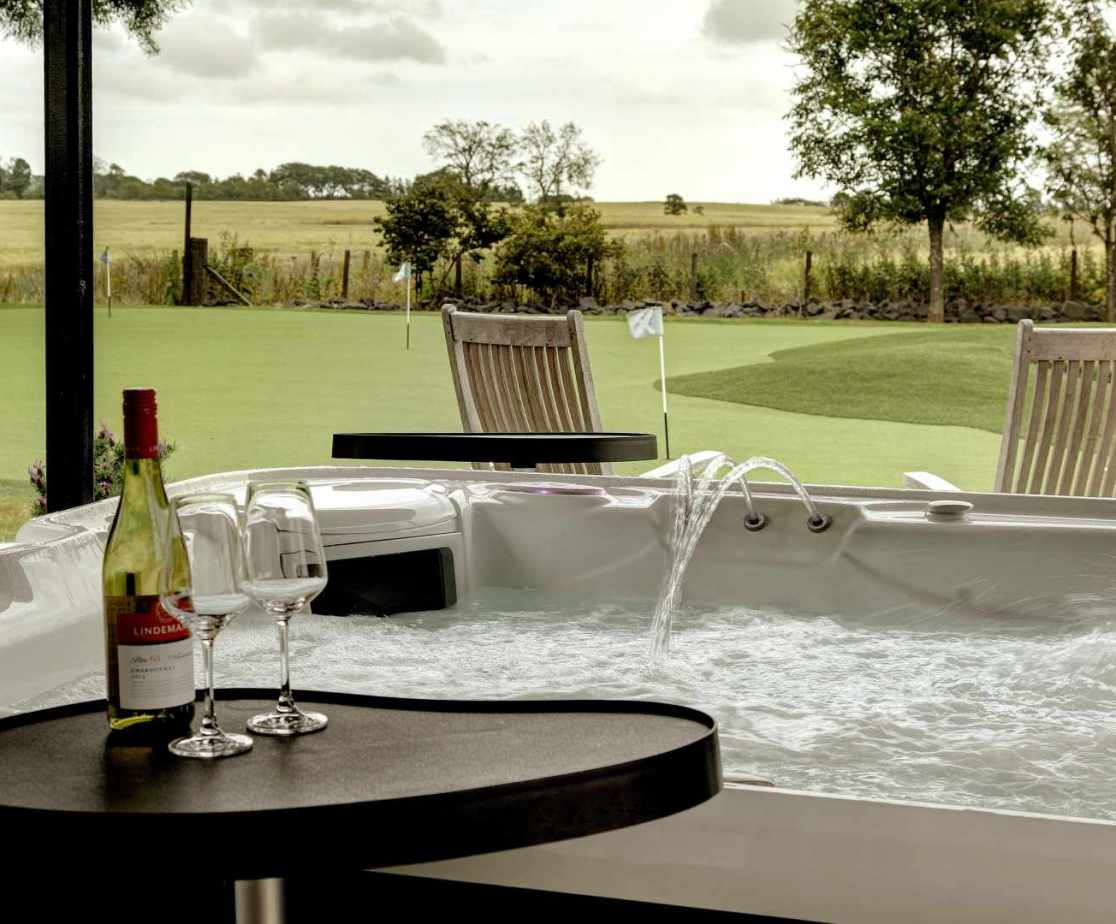 Enjoy a relaxing soak in the hot tub overlooking the private grounds