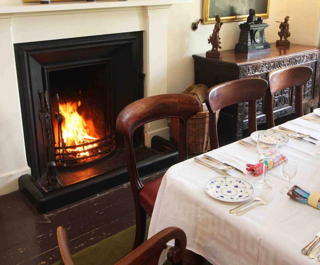 The open fire in the dining room adds extra warmth