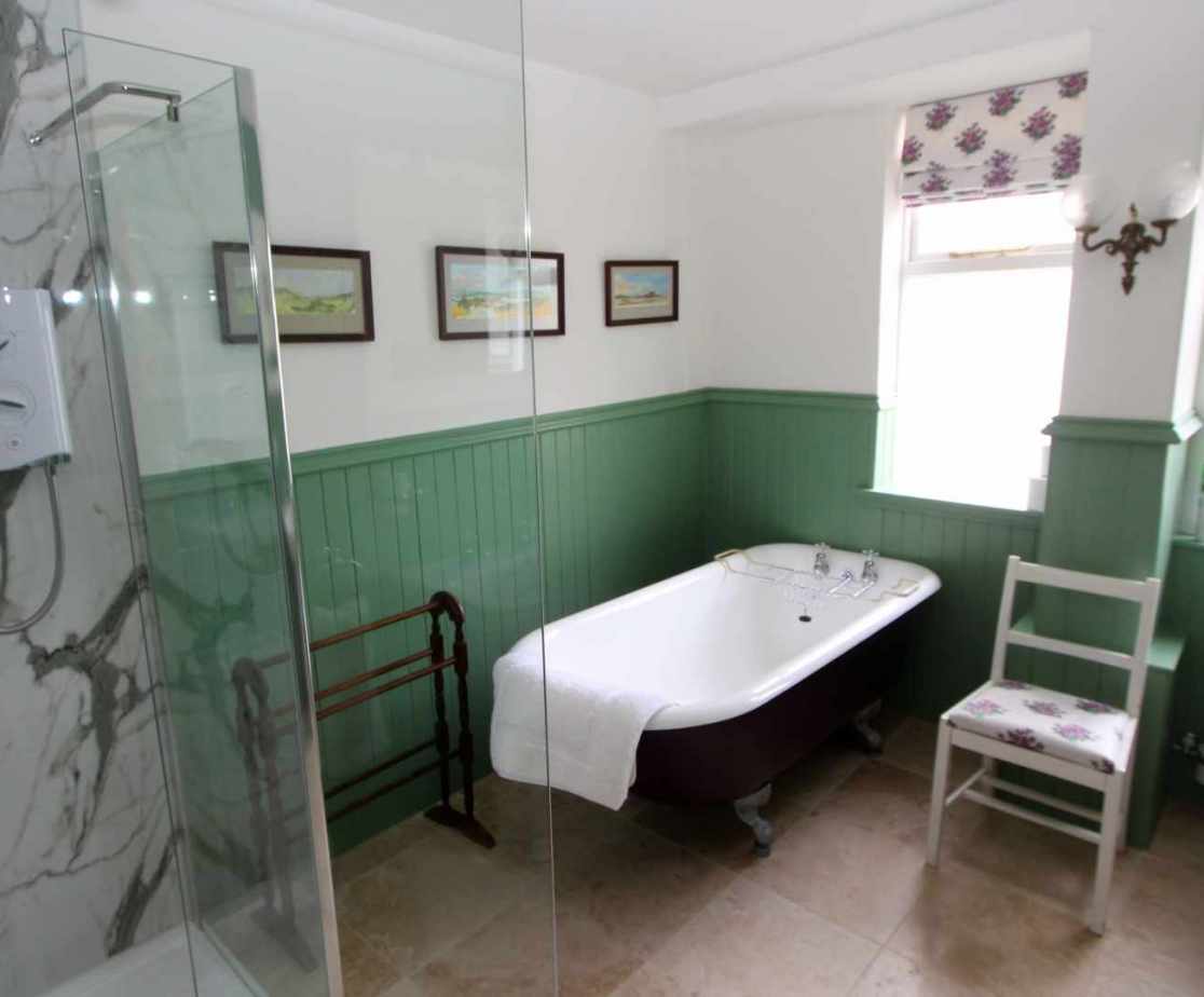 Ground floor shared bathroom with a vintage clawfoot tub and shower cubicle