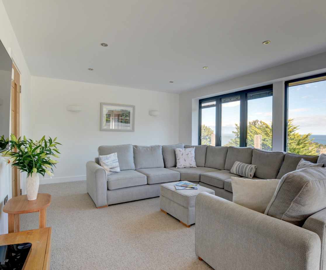 Stunning sitting room with ample seating and huge windows to enjoy the spectacular views