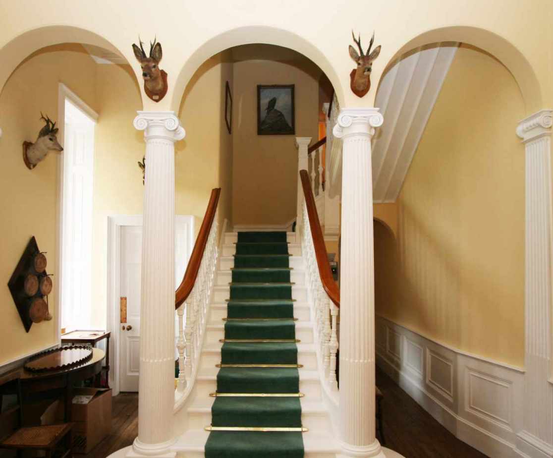 A fine feature staircase with triple arch leads to the accommodation levels