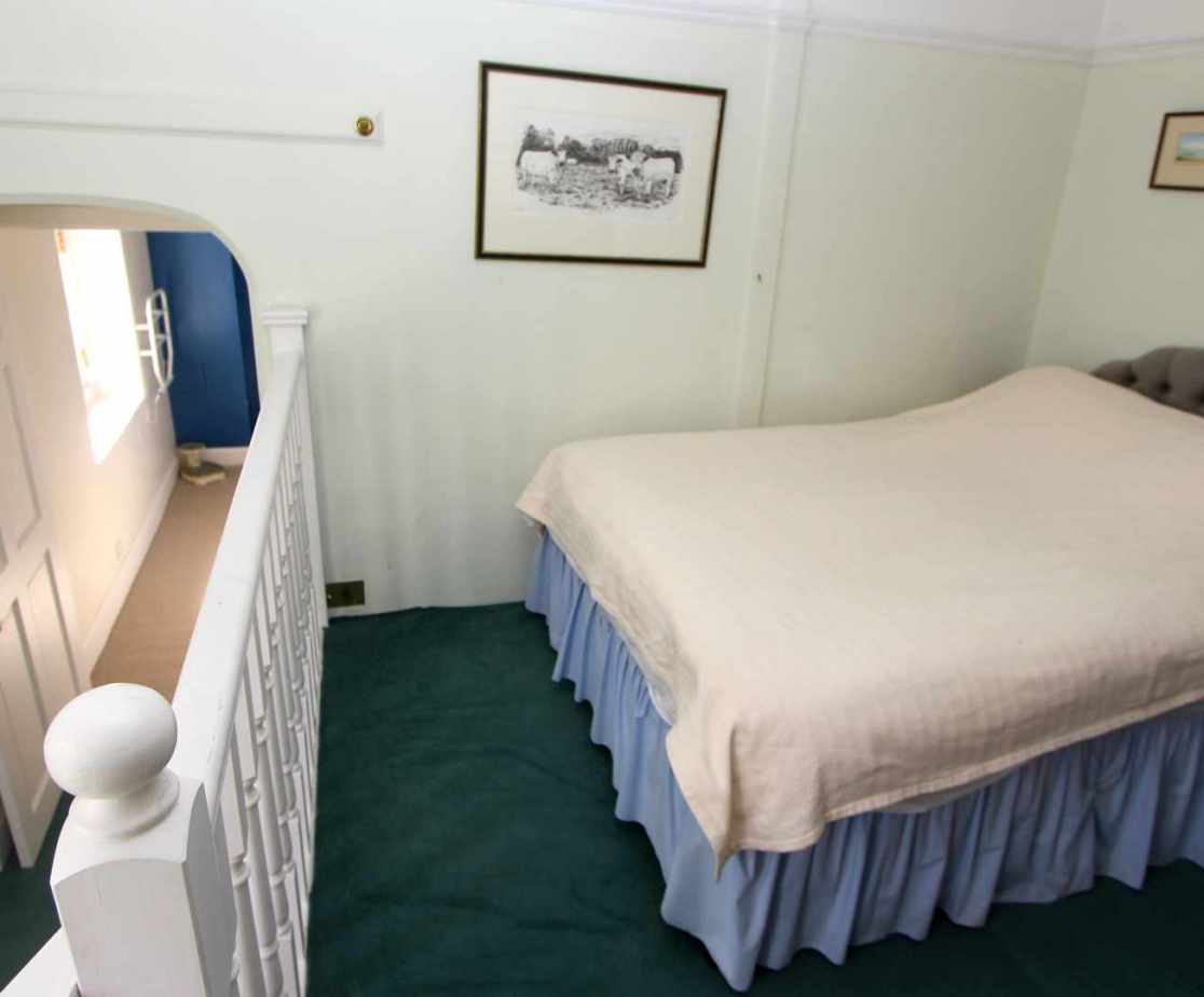 \'Sewing\' room with a double bed has a front view, located on the first floor