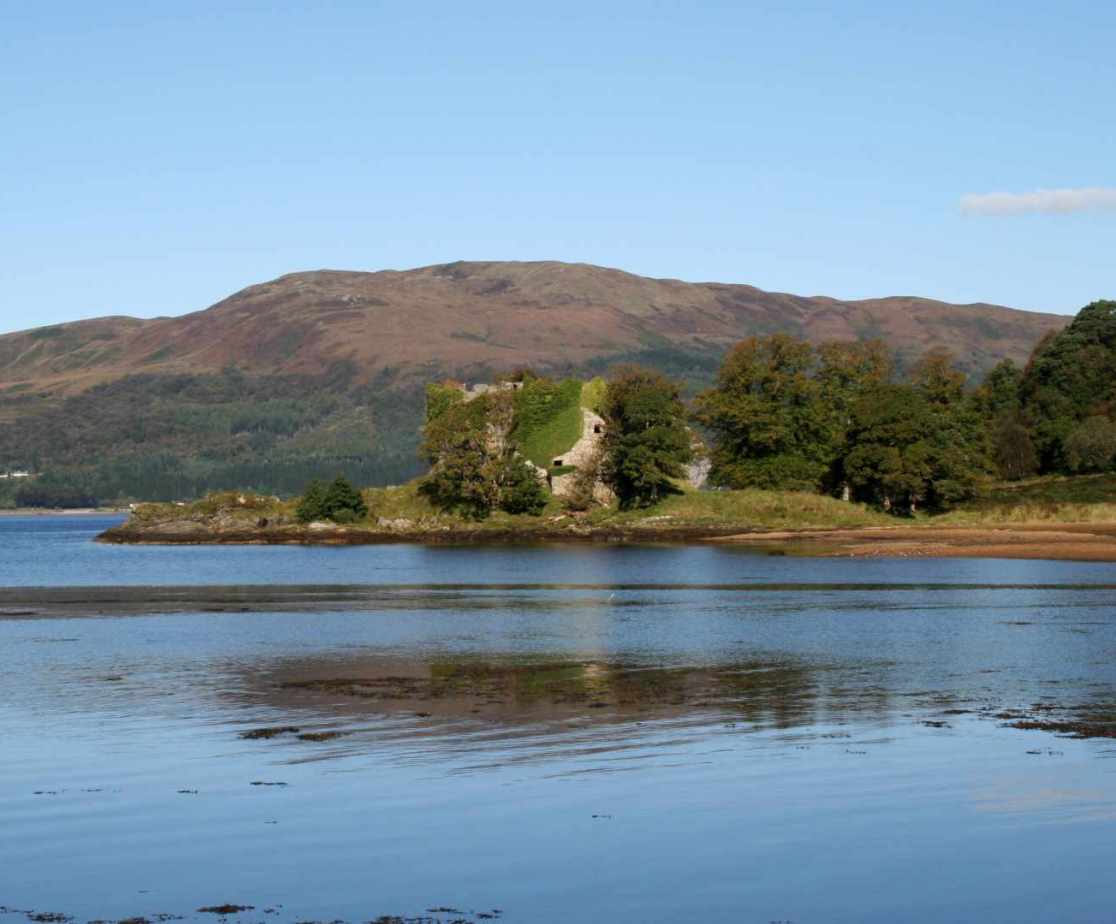 The view across the water to the ruined castle on the estate