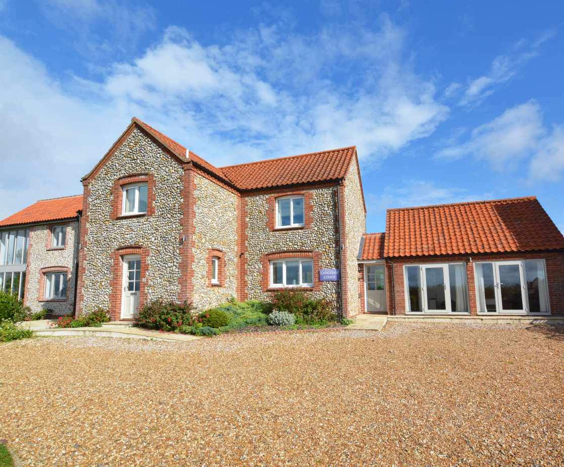 Exterior image of this stunning brick and flint house