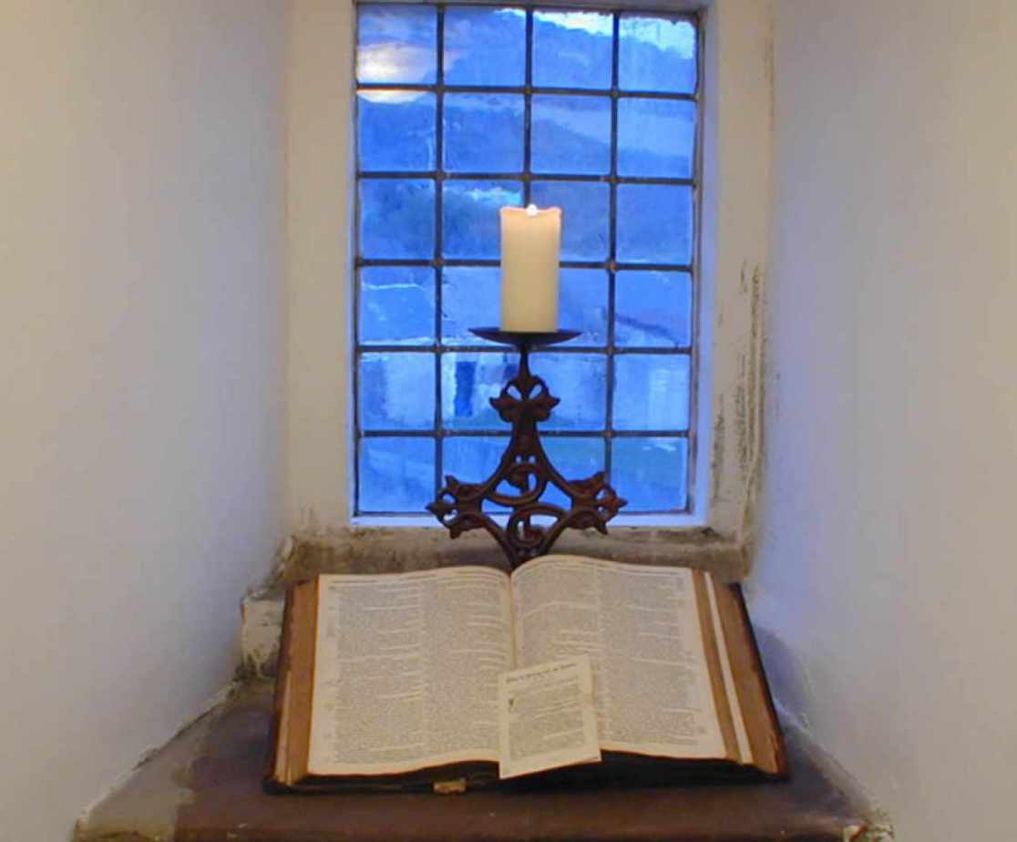 A book, candle and window