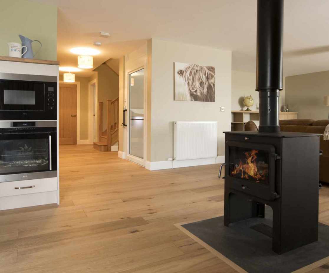 Luxury Perthshire Farmhouse, open plan kitchen, sitting and dining with double sided woodburner