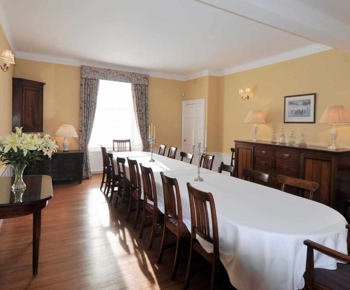 The Formal Dining Room is a classic contemporary space with mahogany dining table up to 20 guests.